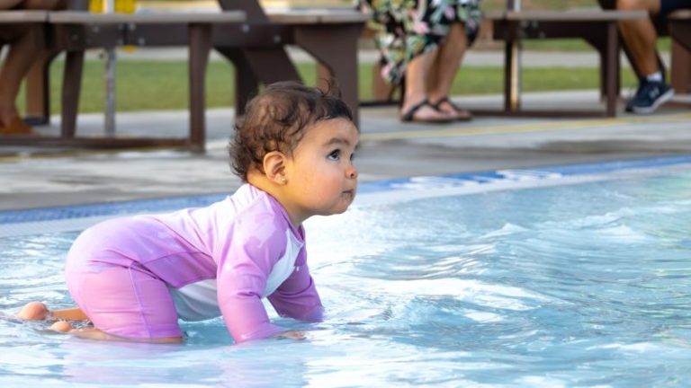 Zero Depth Pool - Infant crawling along safely in the pool.