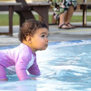 Zero Depth Pool - Infant crawling along safely in the pool.
